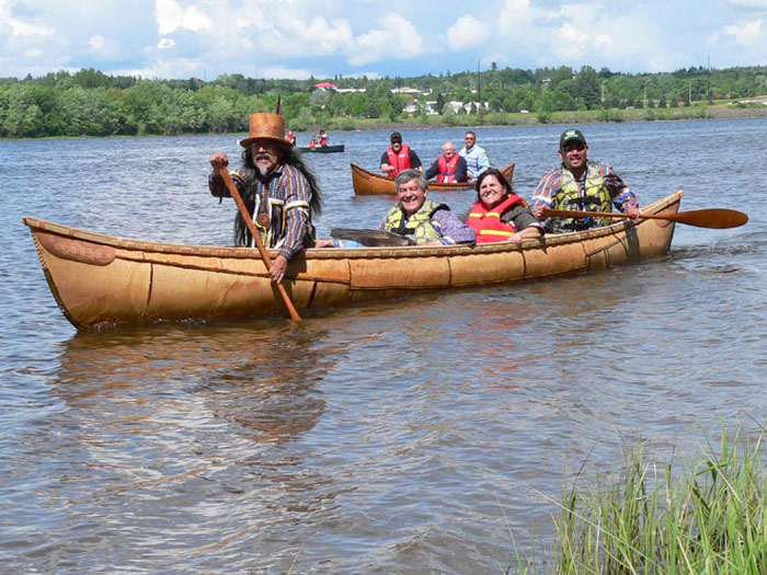 The grandmother canoe, paddled by Wayne and Kim Brooks, with Andrea Bear Nicholas riding amidships